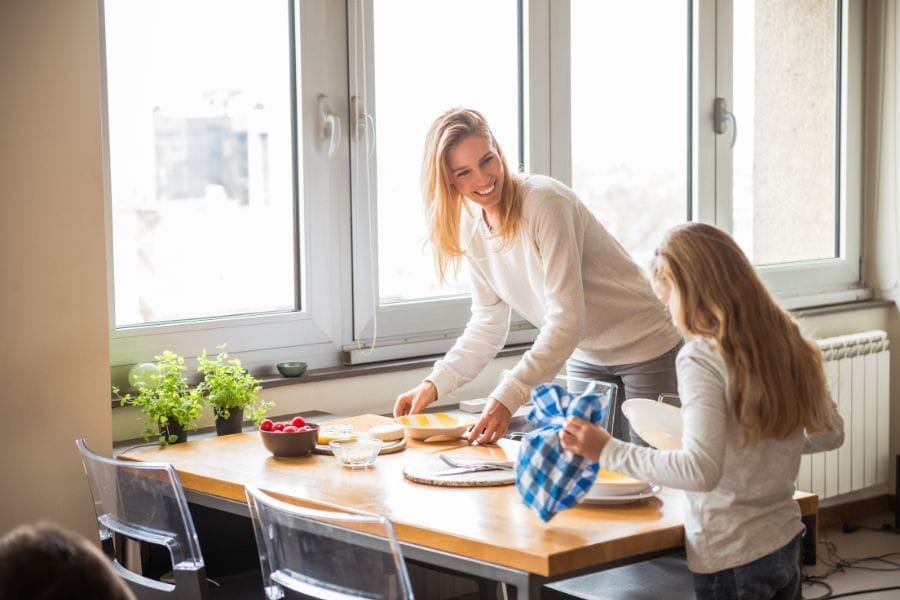 A family practicing hospitality by sharing a meal with neighbors.