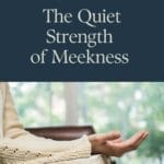 Open Bible resting on a woman’s lap with her hand gently raised in a posture of prayer, symbolizing quiet strength, trust, and surrender to God—reflecting the theme of biblical meekness.